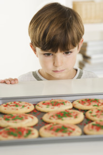 Little boy eyeing cookies.