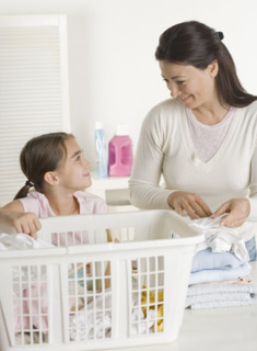 Mother and daughter doing laundry.