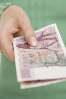 Woman holding Korean money.