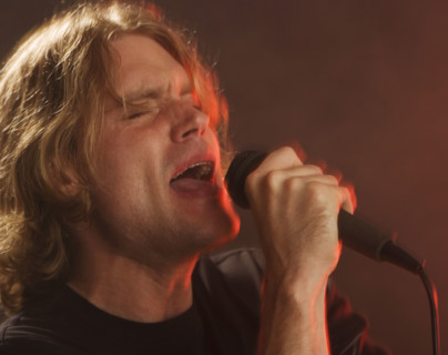 Man singing into microphone.