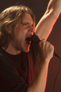 Man singing into microphone.