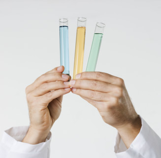 Hand holding test tubes.