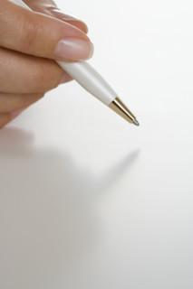 Closeup of hand holding pen.