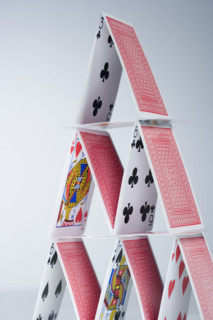 Playing cards stacked into a pyramid.