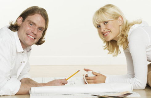 Portrait of couple with blueprints.