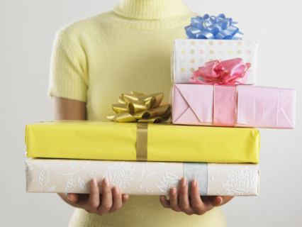 Woman holding pile of presents.