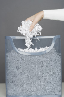 Woman using shredding machine.