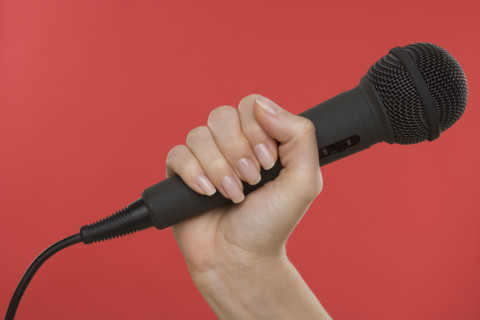 Woman holding microphone.