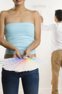 Woman holding color samples.