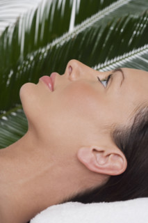 Woman lying on her back at spa.