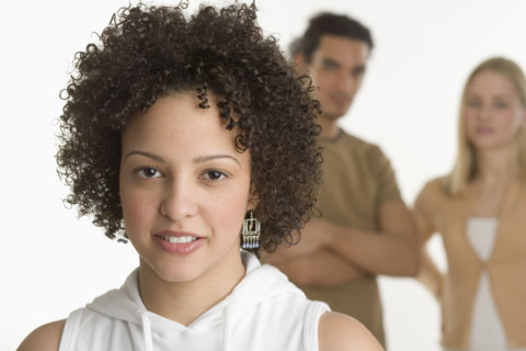 Portrait of young woman with two friends.