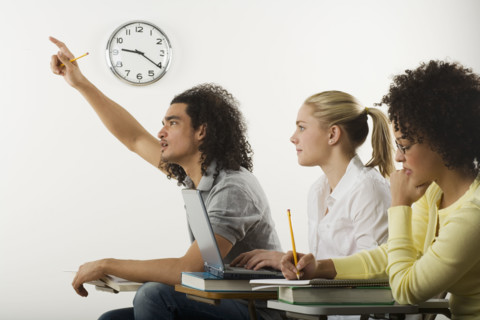 Three college students in class.