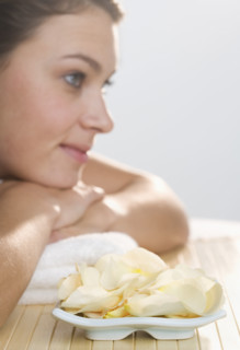 Woman with plate of flower petals.