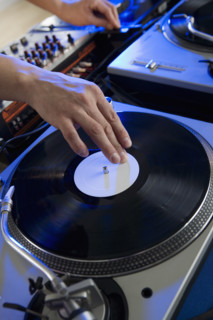 Person mixing music in a nightclub.