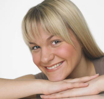 Studio shot of woman smiling.