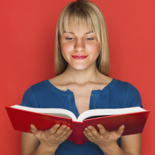 Studio shot of woman reading a book.