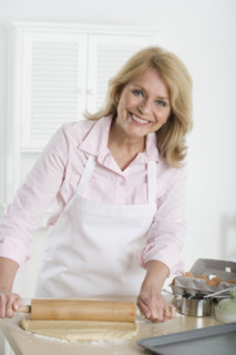 Senior woman rolling dough.