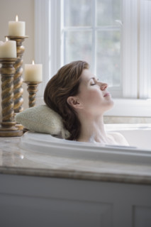 Woman relaxing in bathtub.