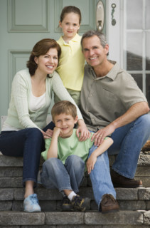 Family sitting on front steps.