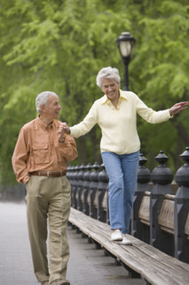 Senior couple walking in a park.