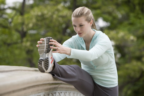 Woman stretching in park.