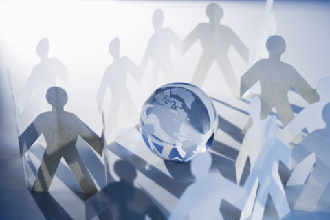 Chain of paperdoll cutouts with globe in center.