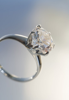 Diamond like ring in six pronged silver setting.