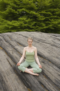 Woman practicing yoga in park.