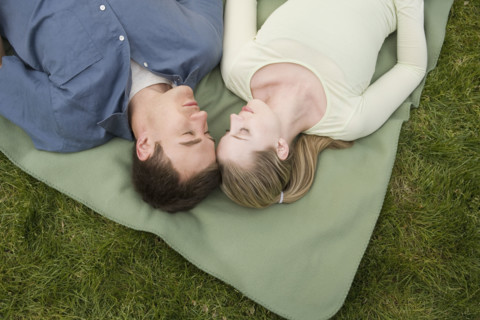 Young couple relaxing outdoors.