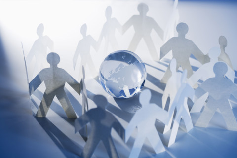 Chain of paperdoll cutouts with globe in center.