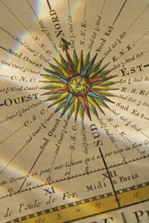 Close up of compass drawn on map.