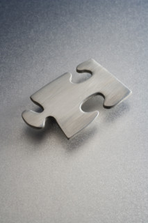 Metallic jigsaw puzzle piece.
