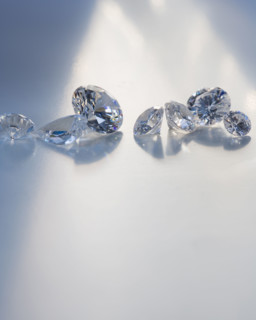 Seven diamond like gems on table.