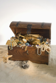 Wooden chest overflowing with treasure.
