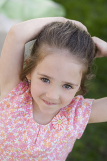 Young girl smiling outdoors.