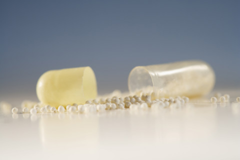 Close up of pill with contents spilled out.