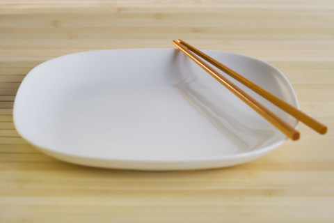Close up of plate with chopsticks.