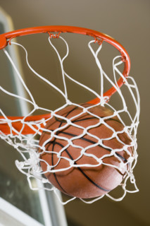 Close up of basketball in hoop.