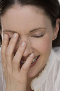 Close up of woman laughing.