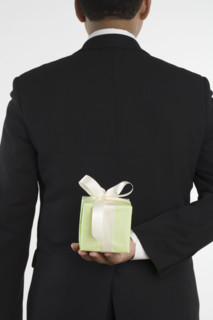 Man holding gift against his back.