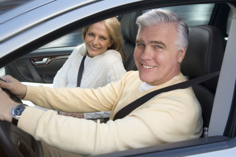 Senior couple driving in car.