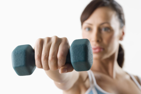 Woman holding hand weight.