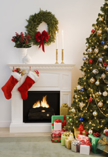 Christmas tree with presents and fireplace with stockings.