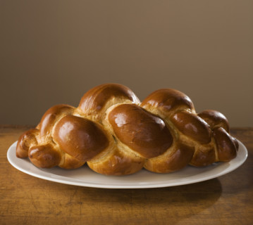 Loaf of Challah bread on platter.