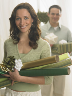 Couple with Christmas gifts and wrapping paper.