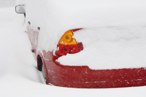 Car buried in snow in winter.