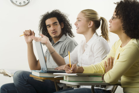 Three college students in class.