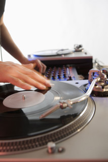 Person mixing sound from records.