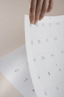 Woman paging through calendar.