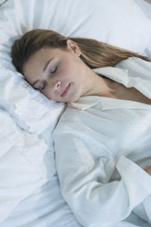 Woman sleeping in bed.